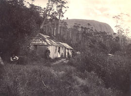 Men standing outside Woods Huts, Mt Wellington